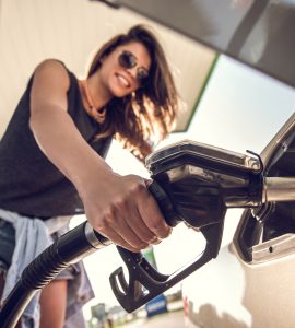 Woman filling up with Kiwi Fuelcards and Saving Money